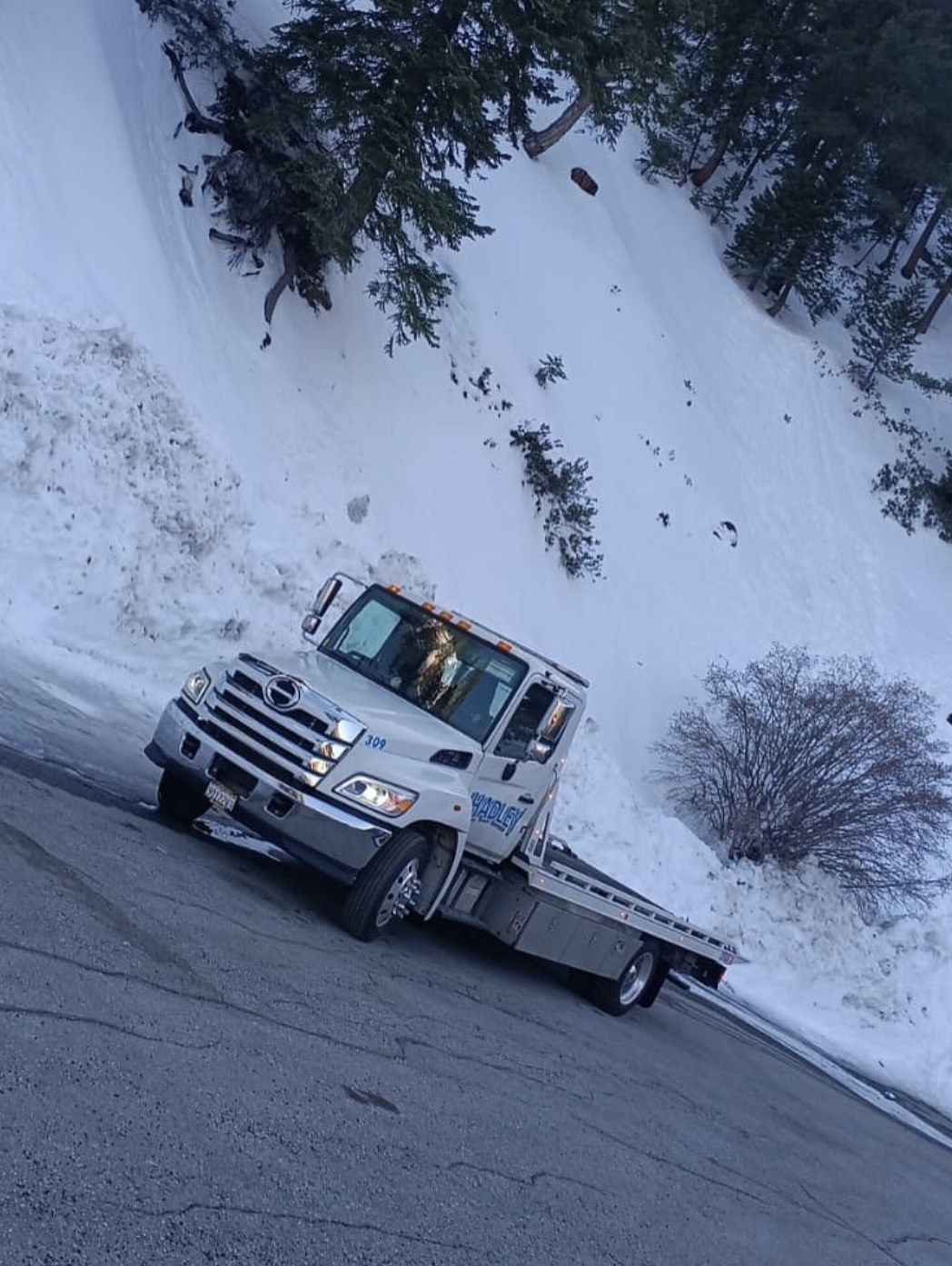 Hadley Tow flatbed #309 on a snowy mountain pull-off in Southern California