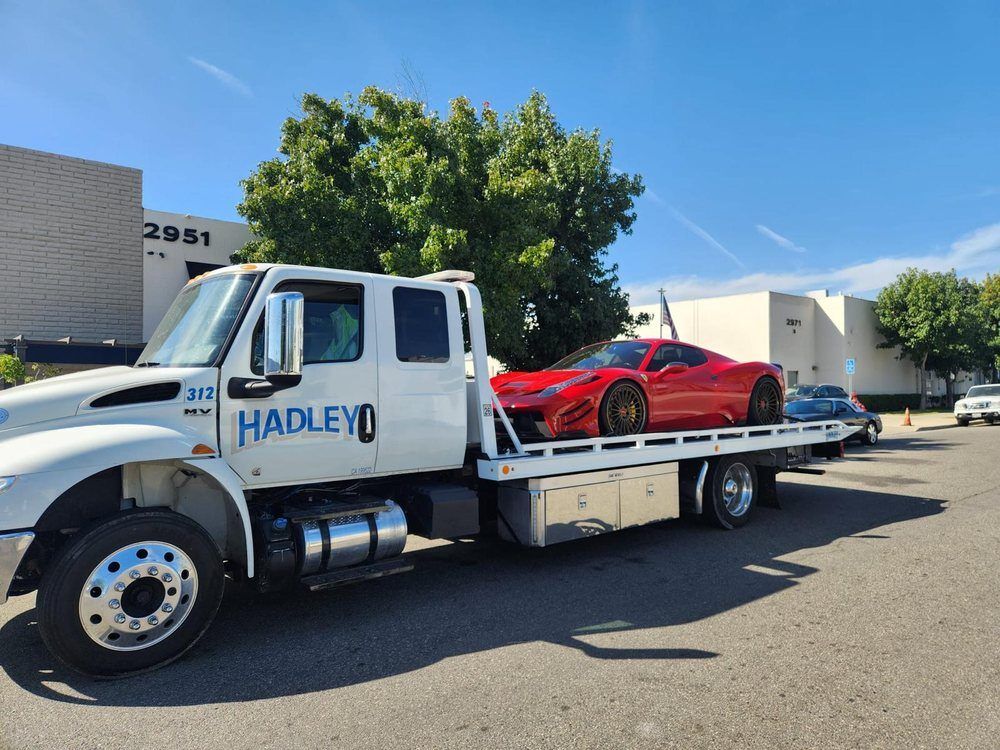 Hadley flatbed transporting a red Ferrari 458