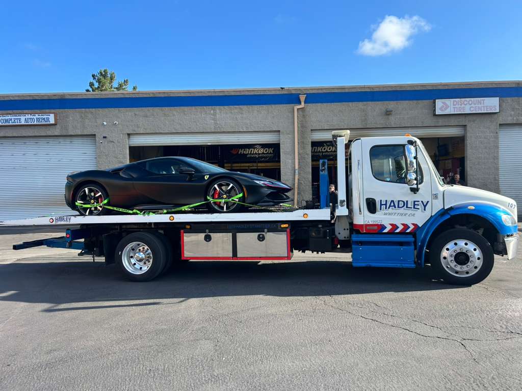 Matte black Ferrari SF90 on Hadley zero-degree flatbed — Whittier